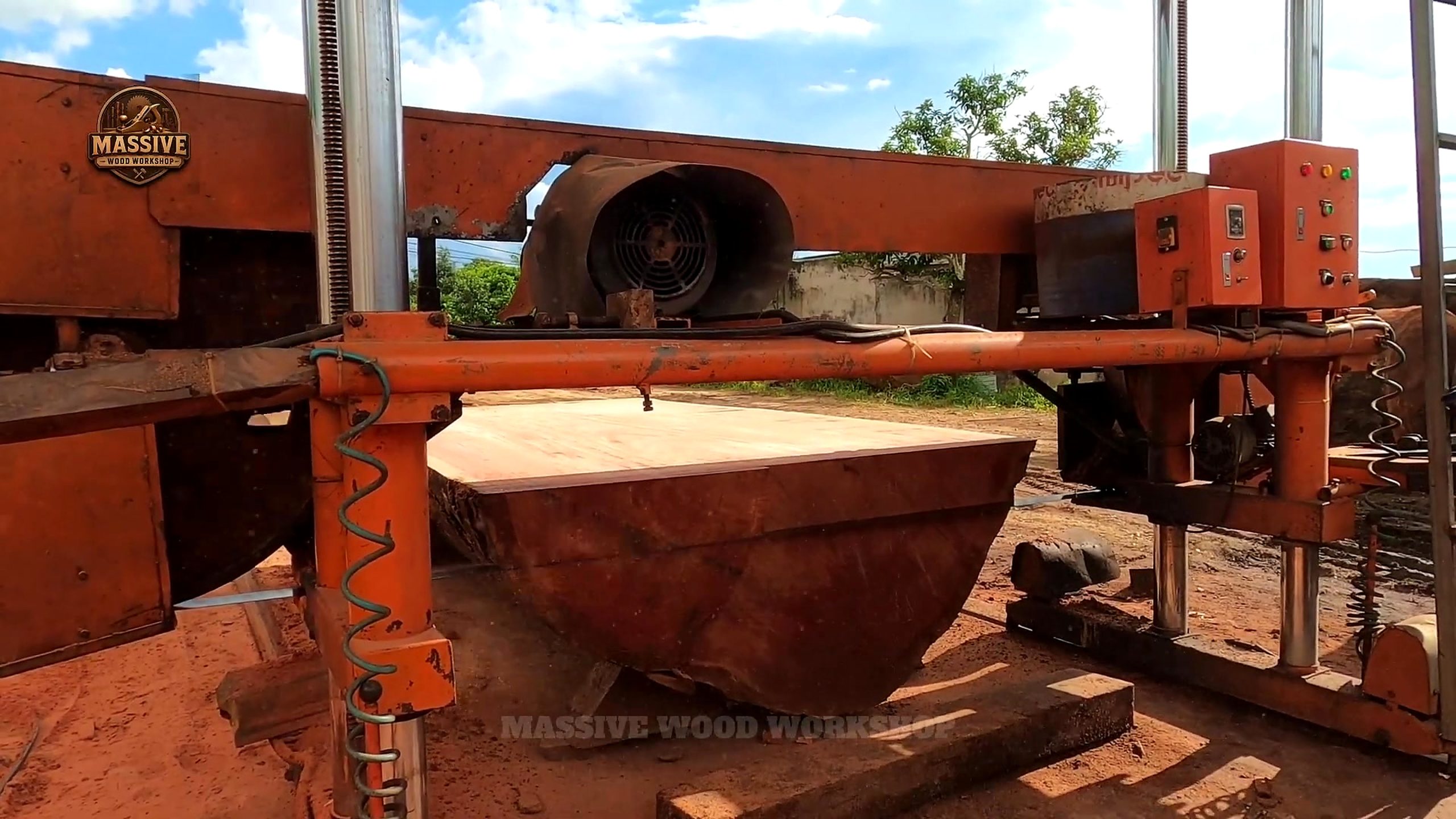 giant log round tabletop cutting process with a half round slab under the band saw