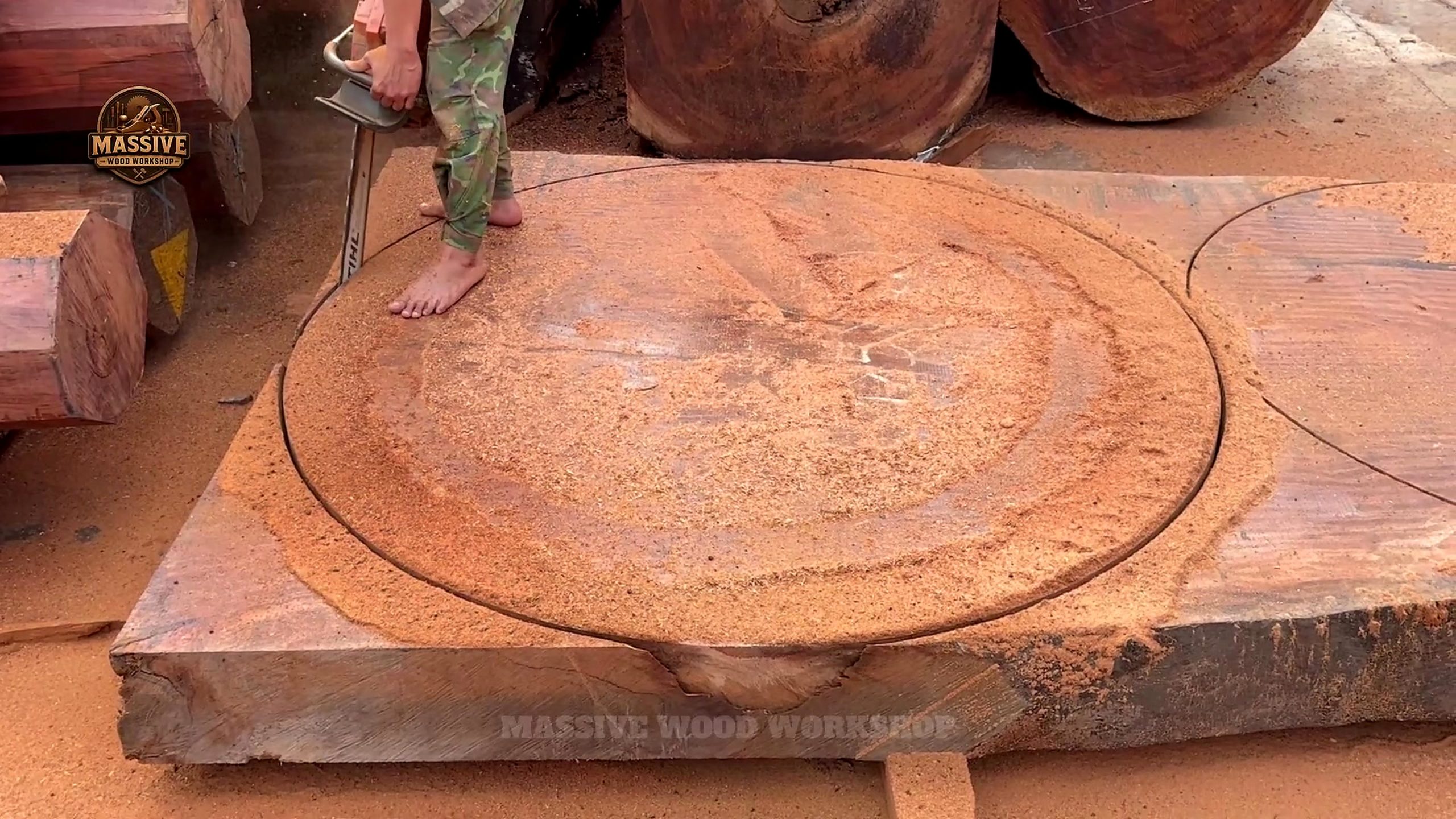 giant log round tabletop cutting process with a circular tabletop line drawn on the slab
