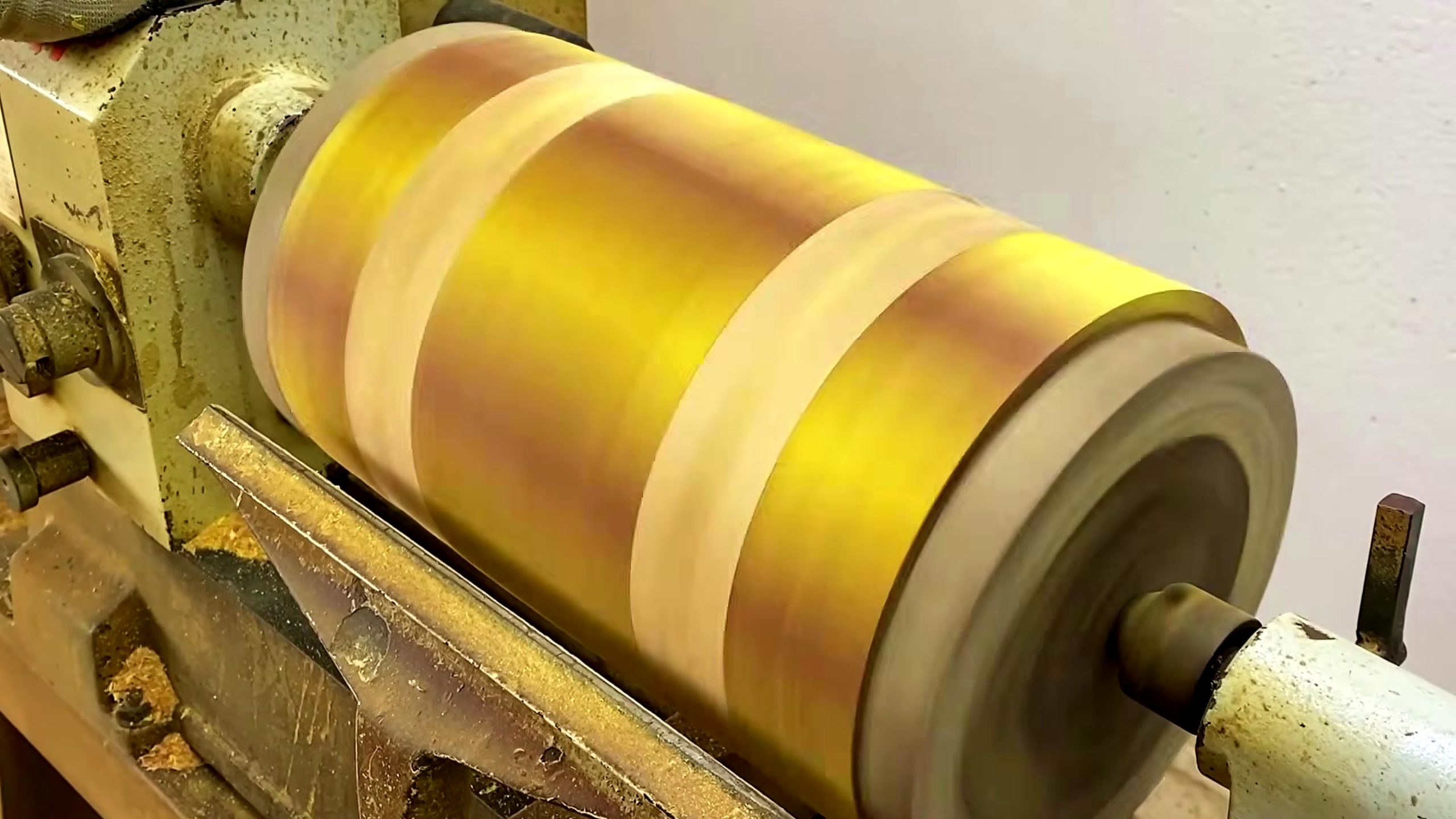 chainsaw log segmented wood bowl process - the segmented blank spinning on the wood lathe during outside shaping