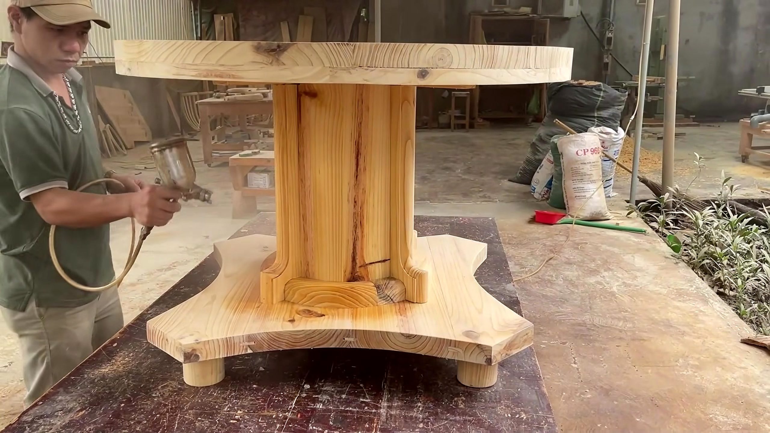 circular wood pedestal lattice furniture workflow - a pedestal-like furniture base or table support being assembled and checked
