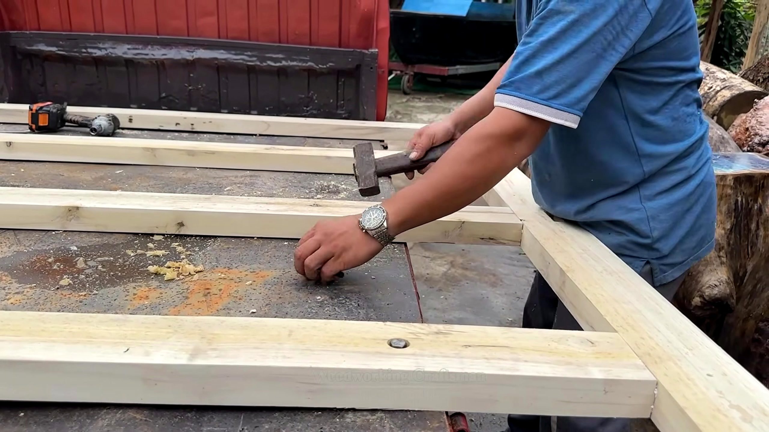 see guy did cherry wood logs layout and fastening stage on prepared boards