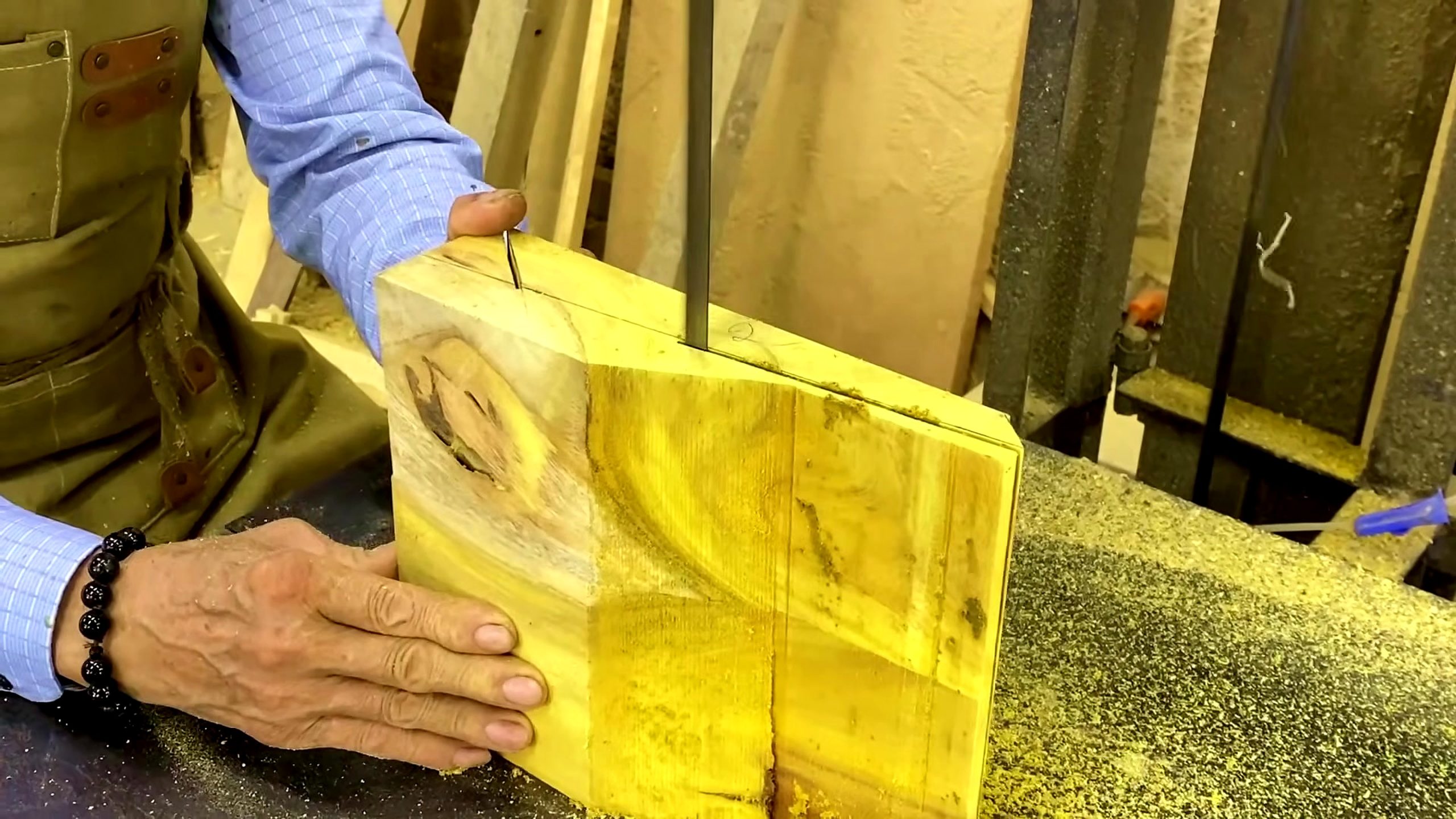 segmented wood lathe bowl process - a yellow laminated block being inspected before shaping begins