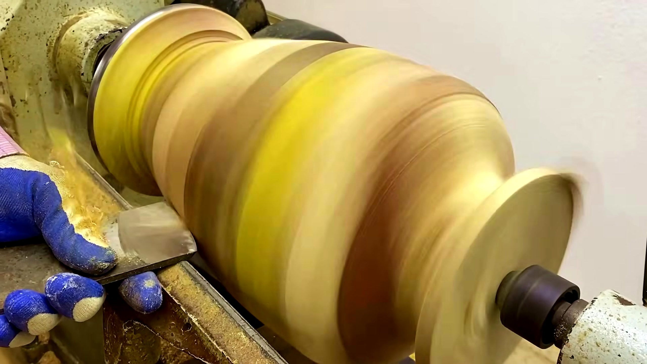 segmented wood lathe bowl process - the hollowed bowl form and rim being reviewed while still mounted on the lathe