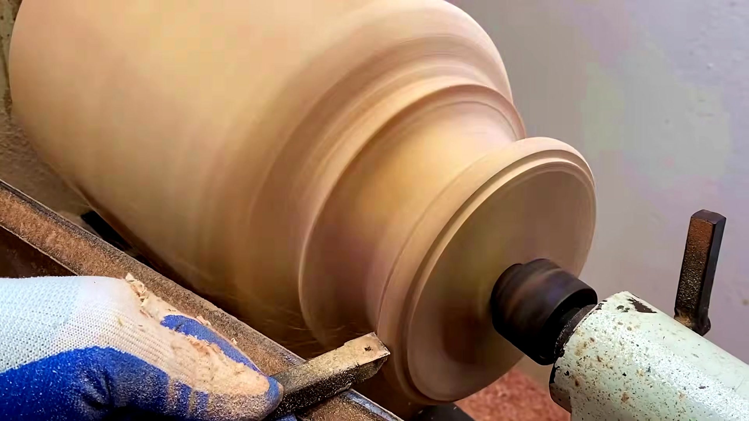 solid wood lathe bowl turning process - the cleaner hollow form and rim profile being reviewed while still mounted