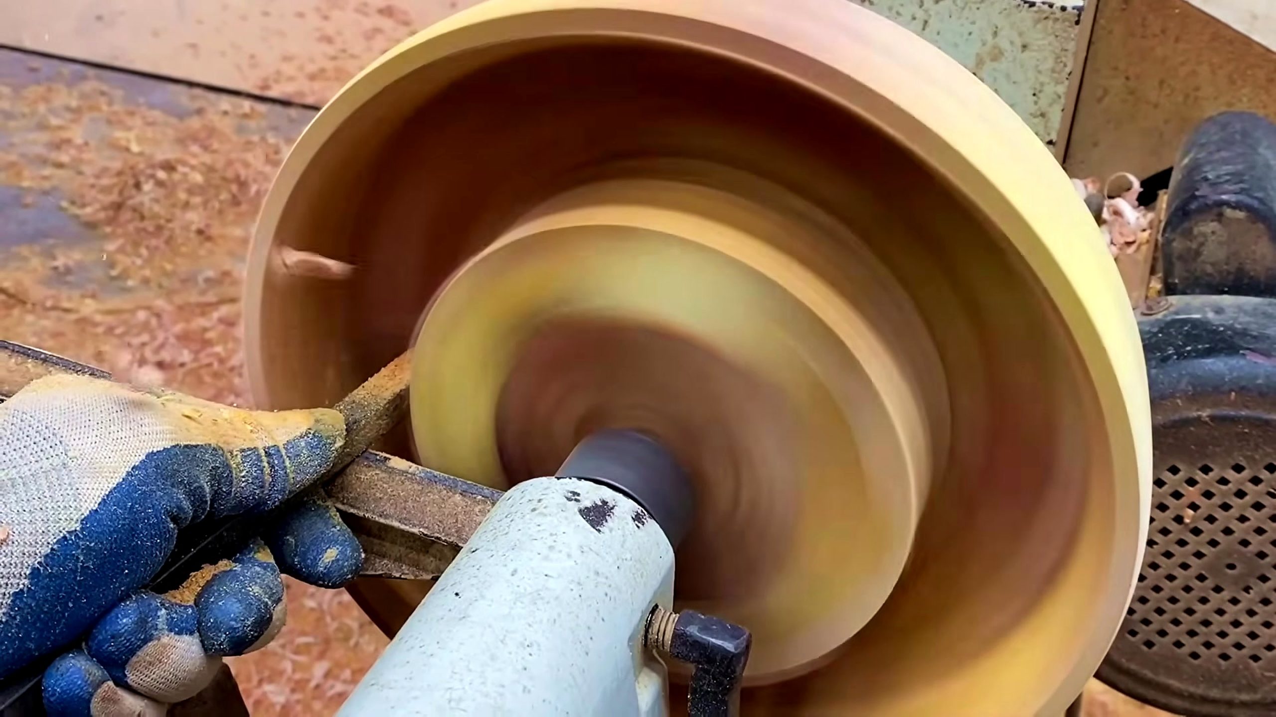 wood lathe segmented bowl process - a turning tool hollowing the bowl and forming the inside curve