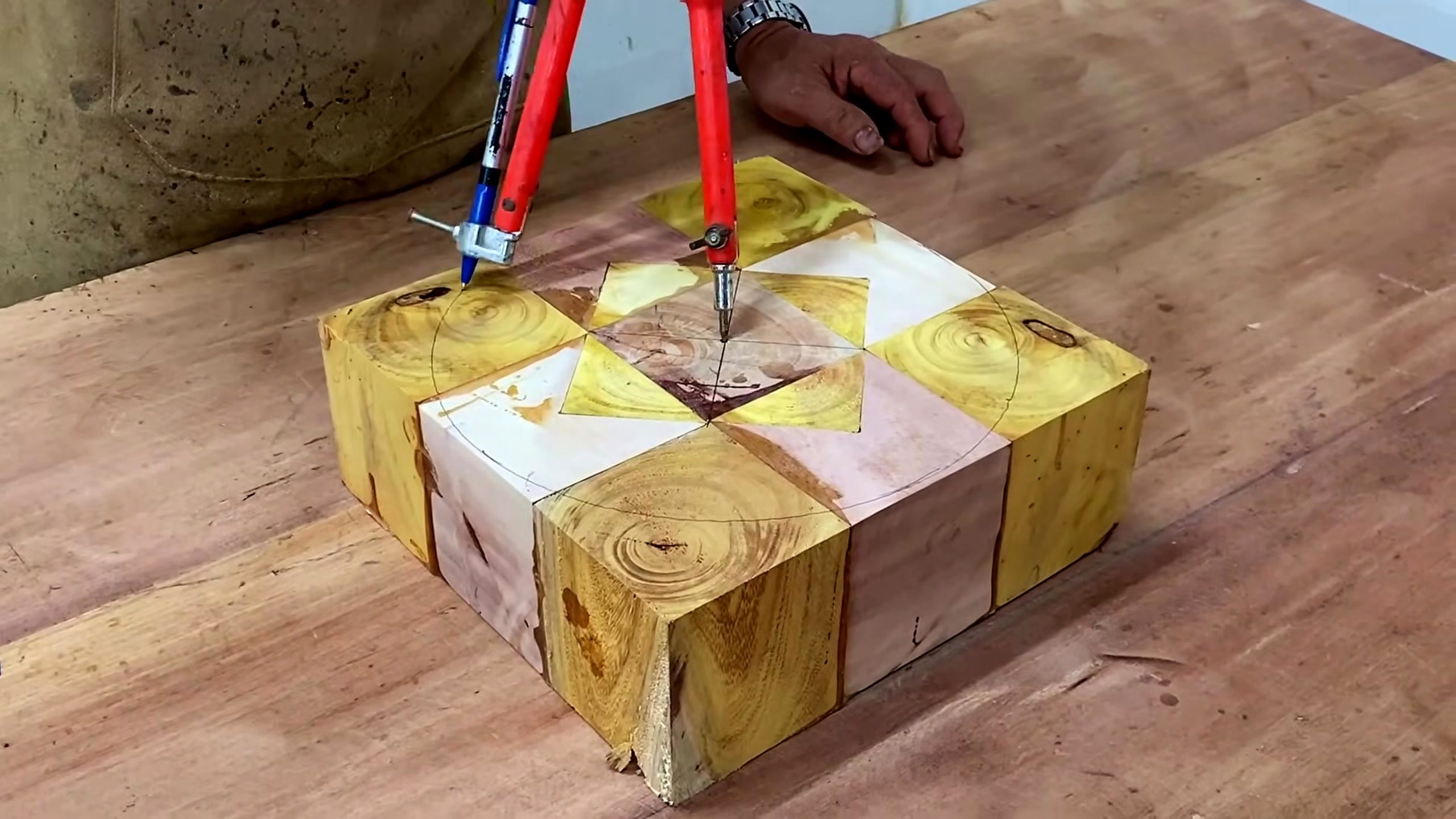 wood lathe segmented bowl process - a segmented wood block marked with a compass circle on the bench