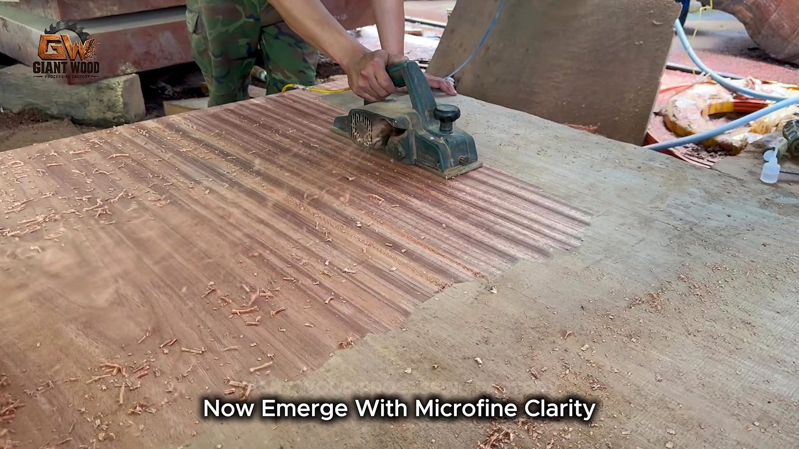 Handheld planer preparing another wide slab before finish in the source video