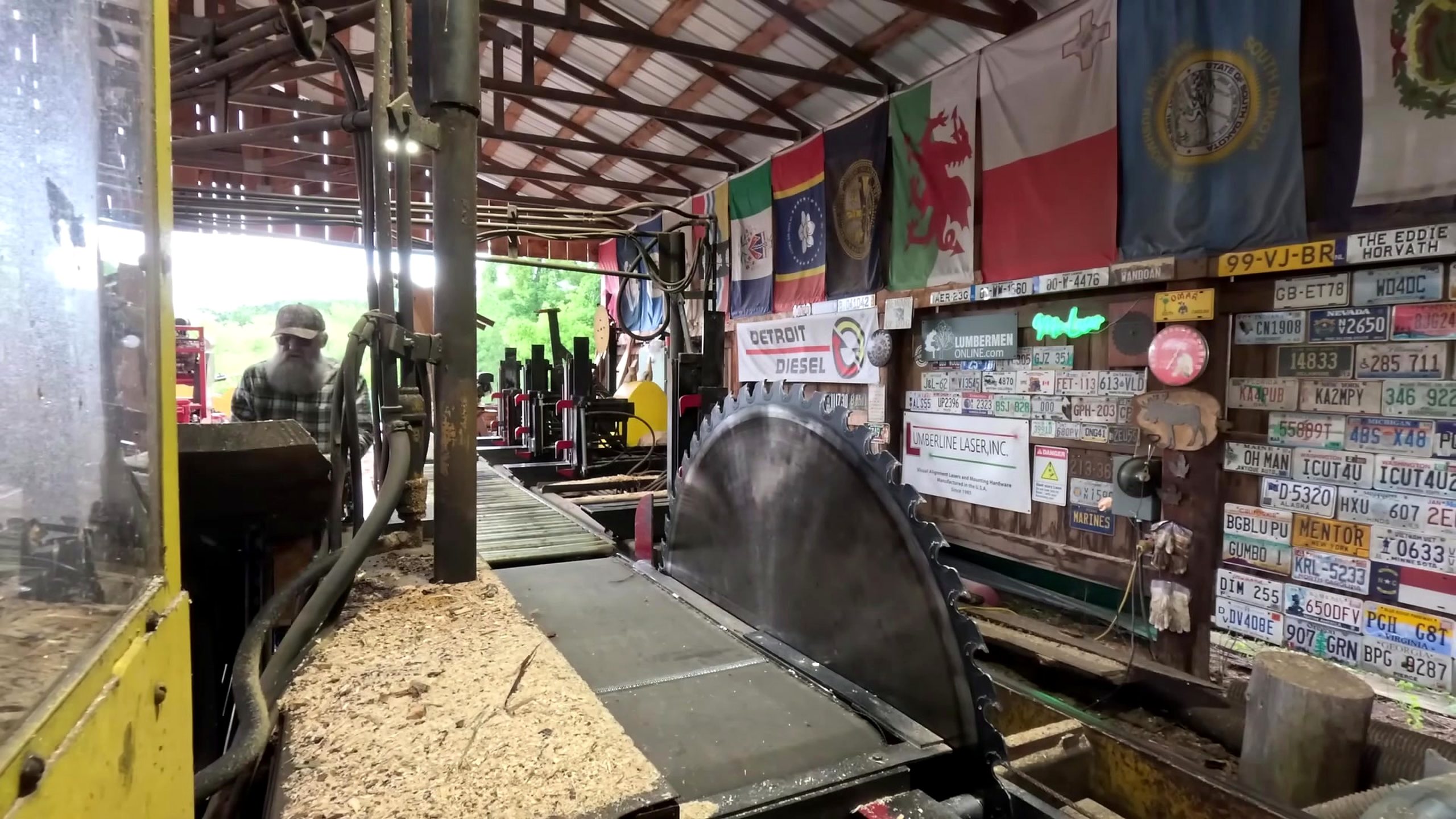 sawing 2x8 boards for a shed floor at the open circular sawmill before the log is loaded