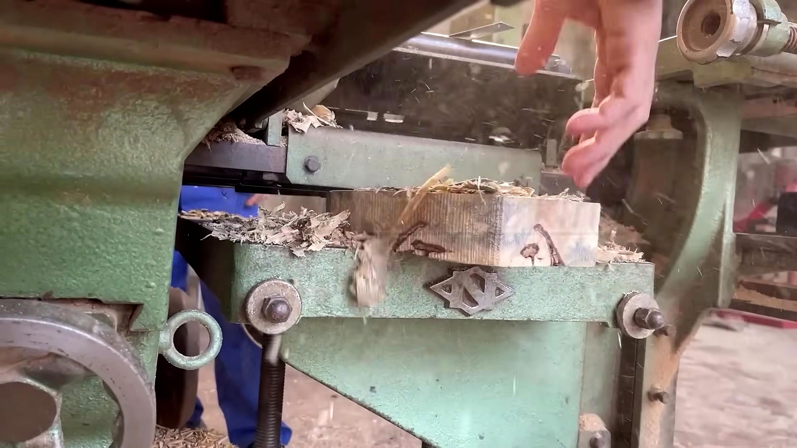 forgotten giant tree stump woodworking process - a green woodworking machine cutting or flattening a small section to create a reference surface