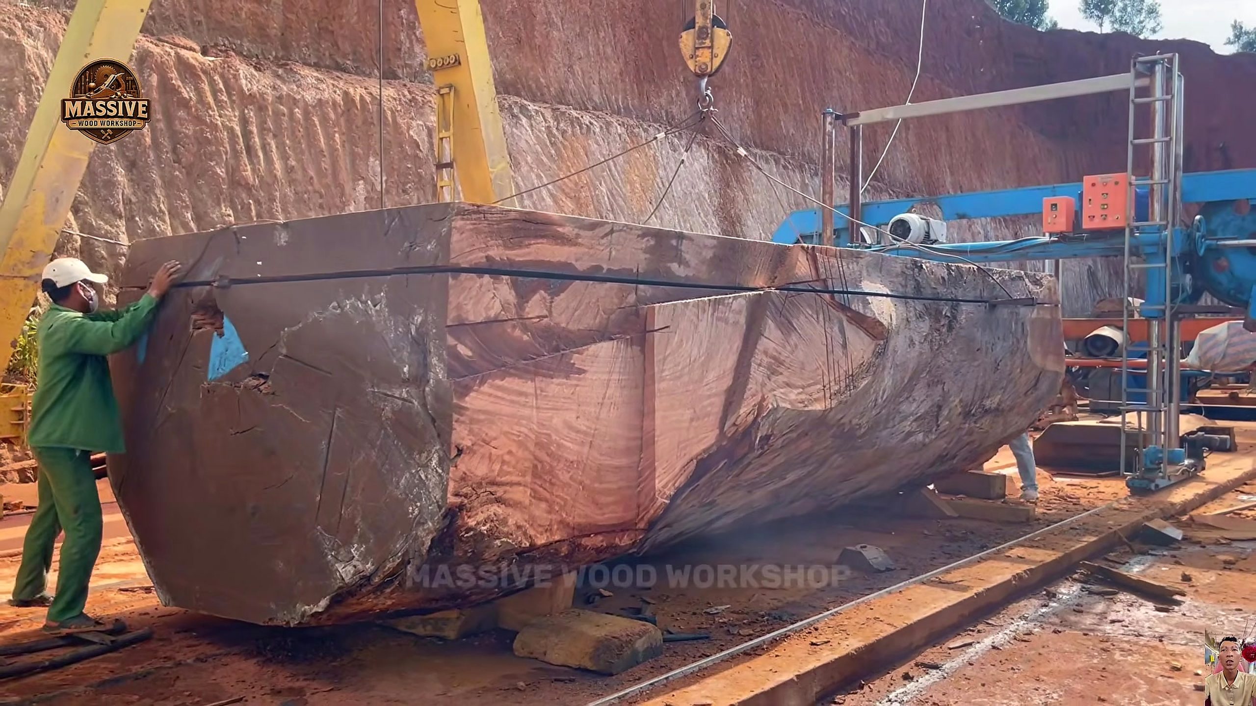 giant timber bandsaw round table process - the long rectangular timber section supported on the cutting bed