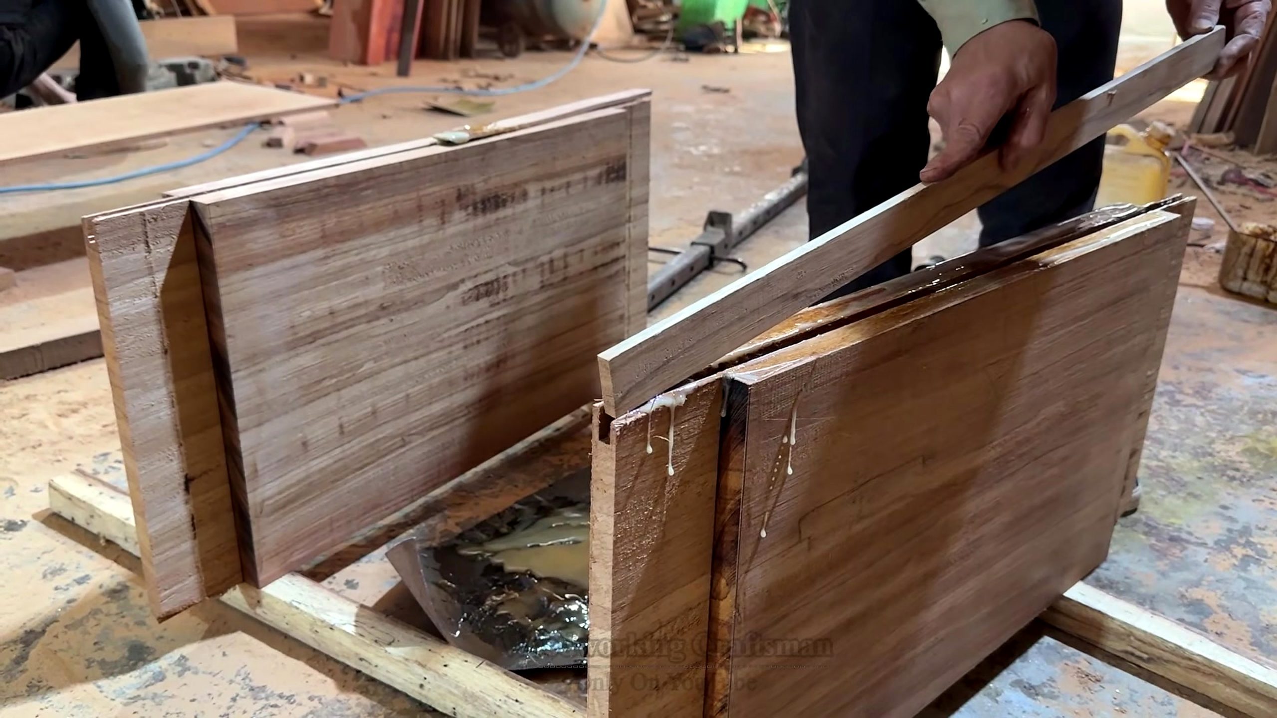giant wooden door handcrafted installation process - large boards or door components staged before the main assembly decision