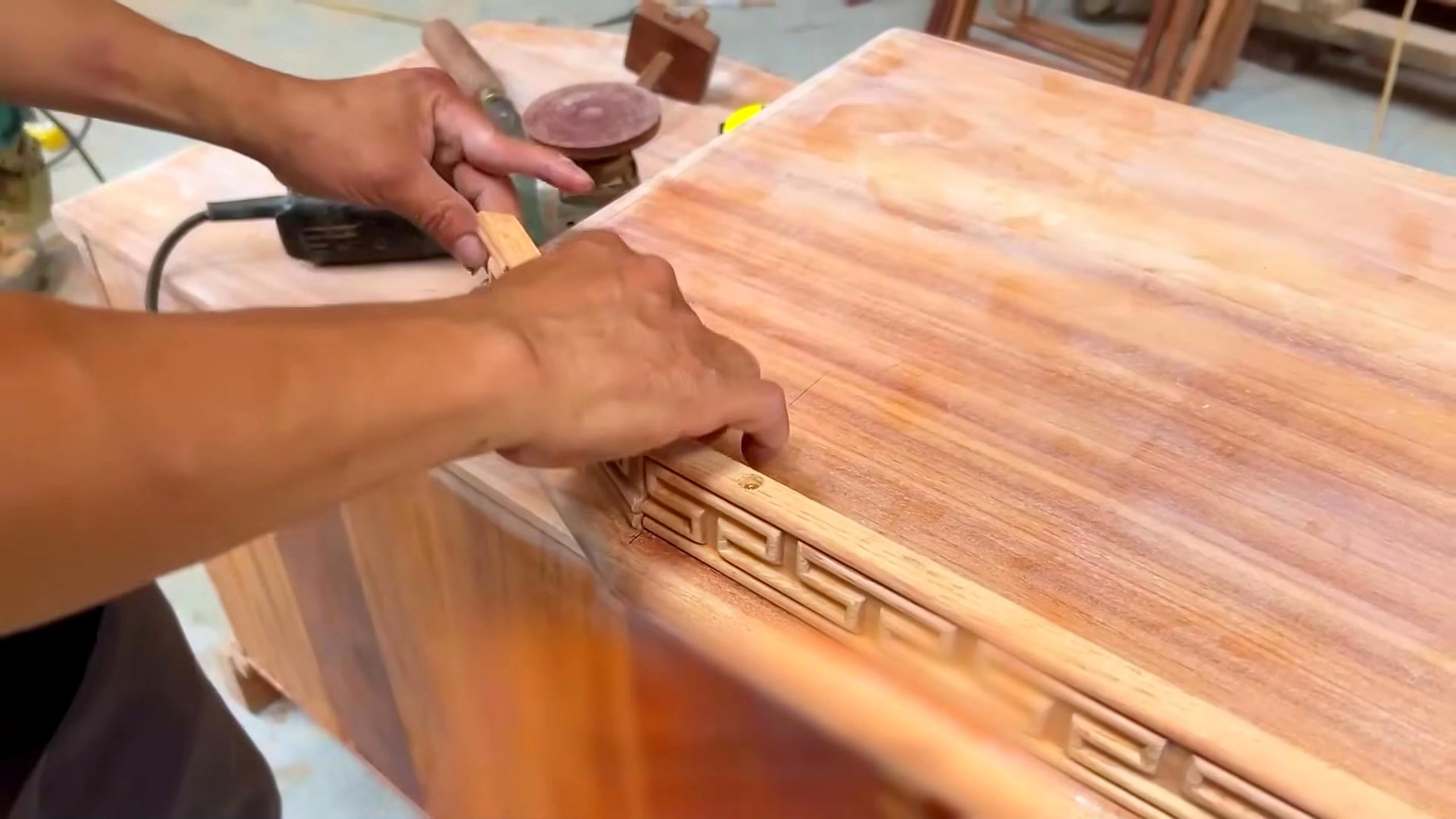 hardwood cabinet frame and panel process - a carved geometric front or top being aligned on the hardwood furniture body