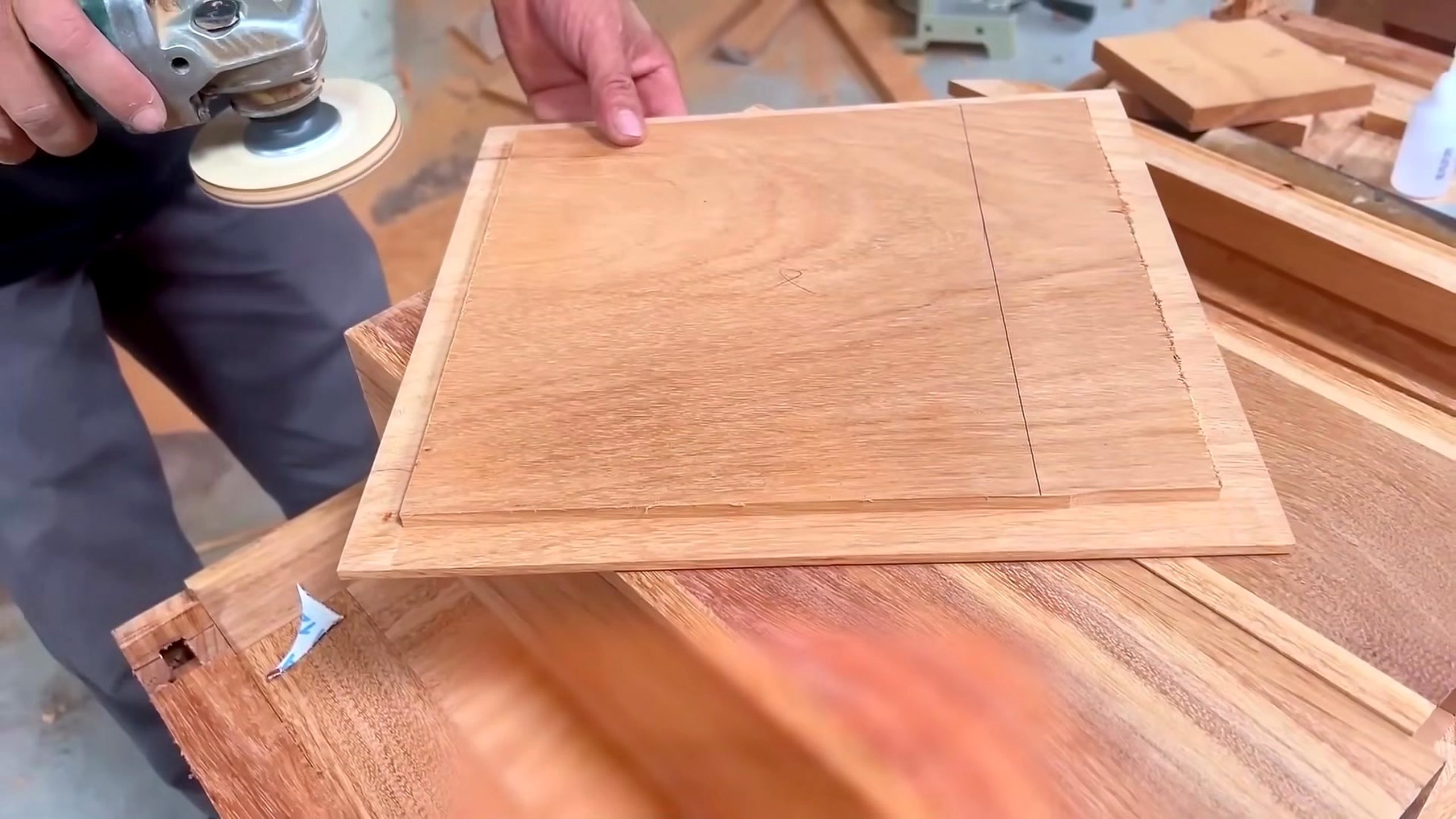 hardwood cabinet frame and panel process - a straight inset groove or cut being guided across a rectangular panel