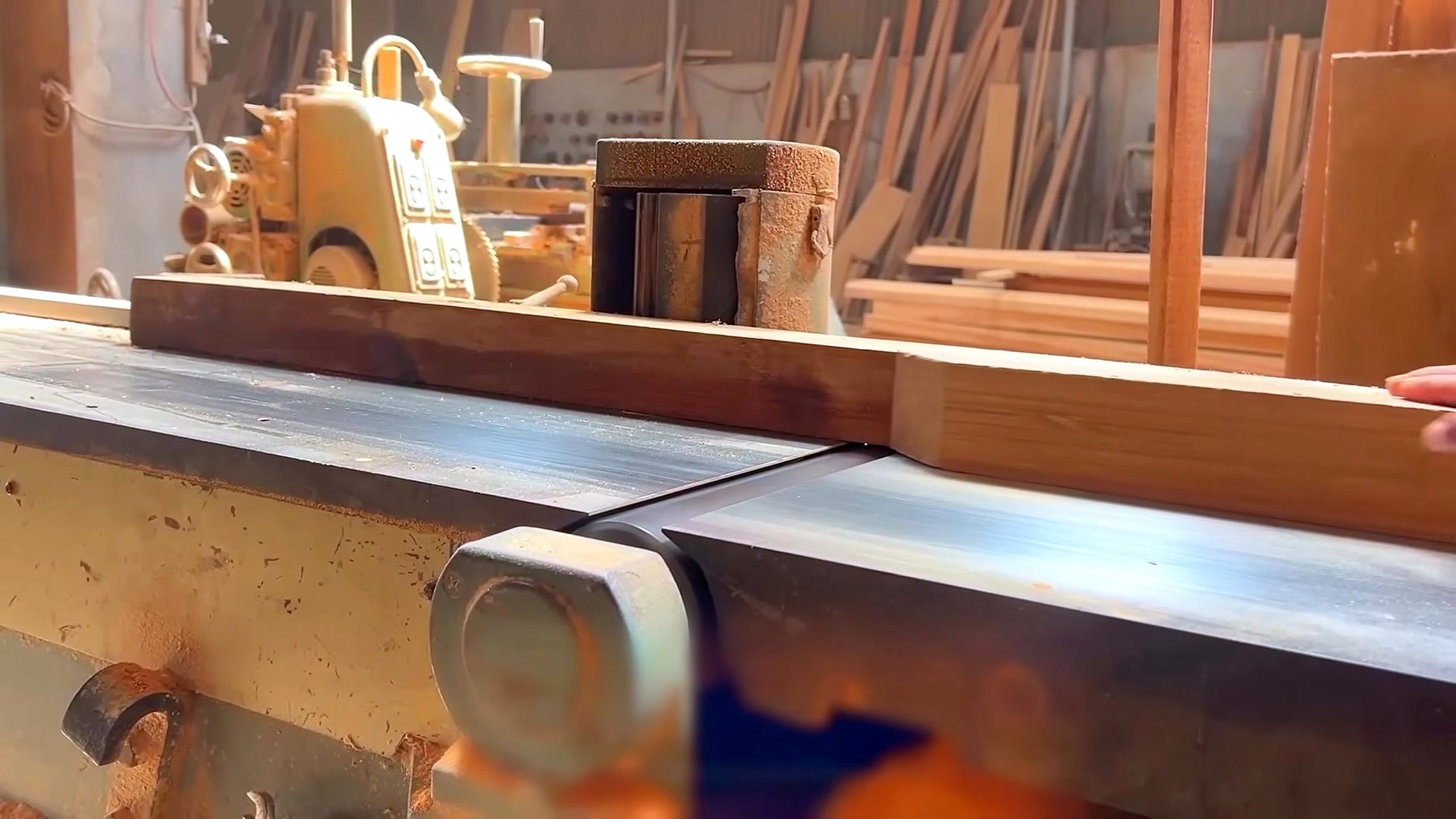 hardwood cabinet frame and panel process - a hardwood frame rail being sized against the table-saw fence