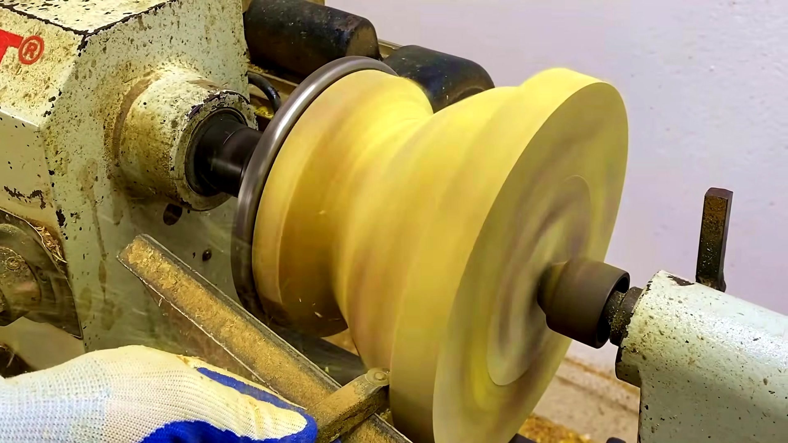 laminated wood disk turning process - the disk rotating on the lathe while its face and edge are rounded