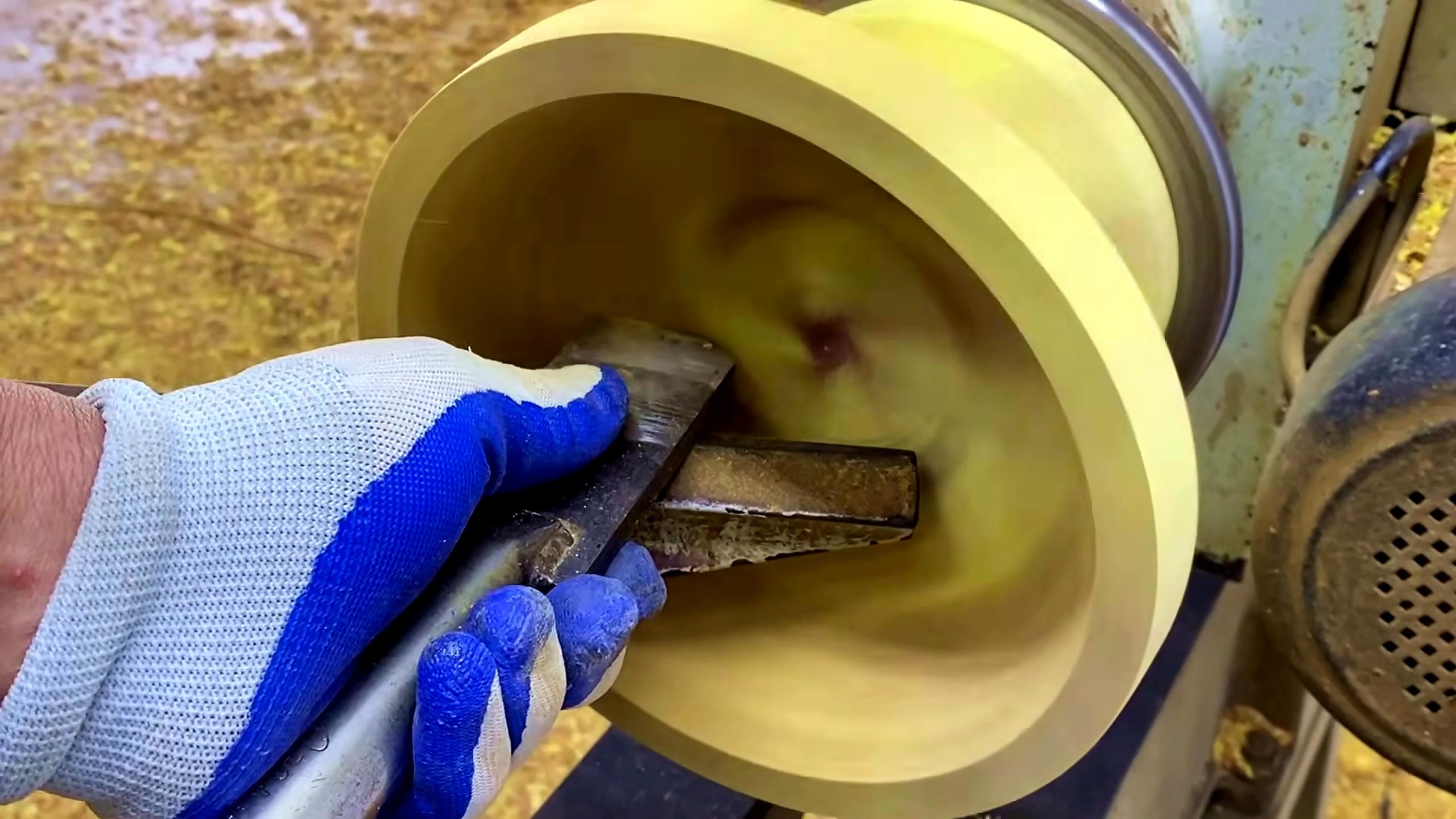laminated wood disk turning process - a hand-held turning tool supported on the rest while shaping the disk face
