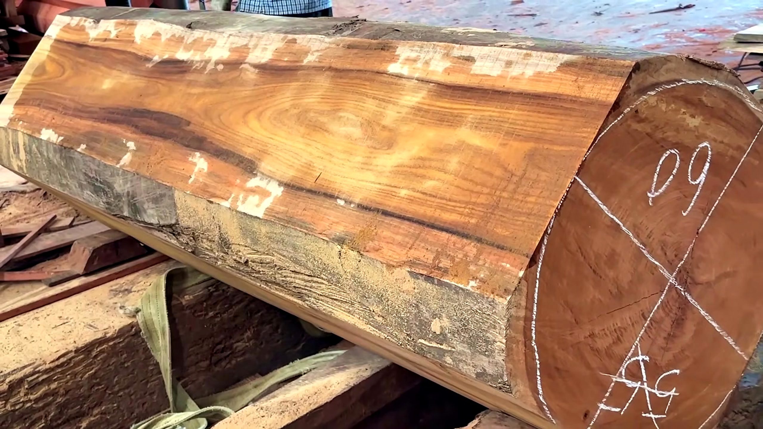 large wood log lathe turning process - the faceted log blank and chalk end-grain layout before mounting