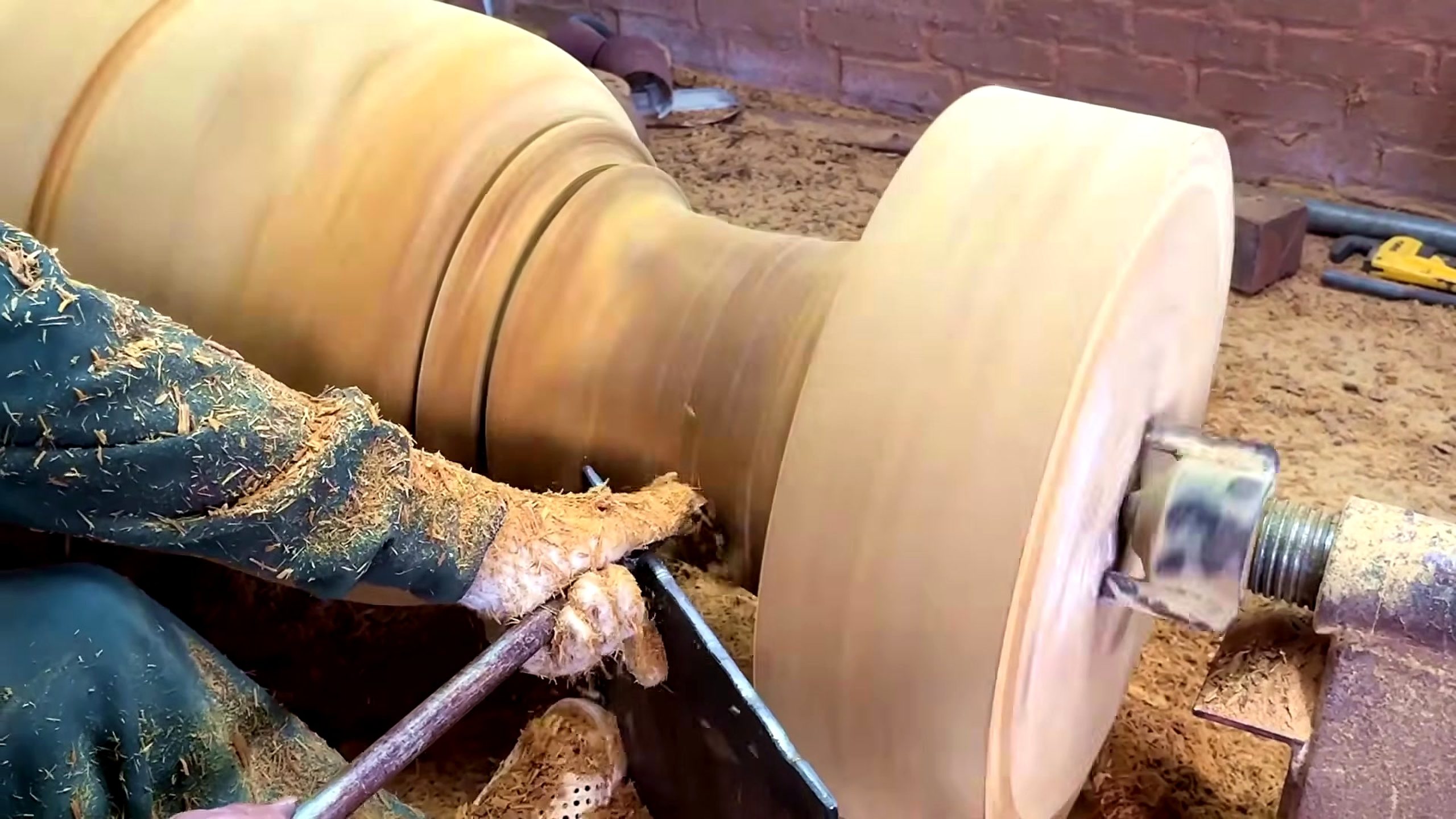 large wood log lathe turning process - a supported turning tool shaping the flared end and reference diameters