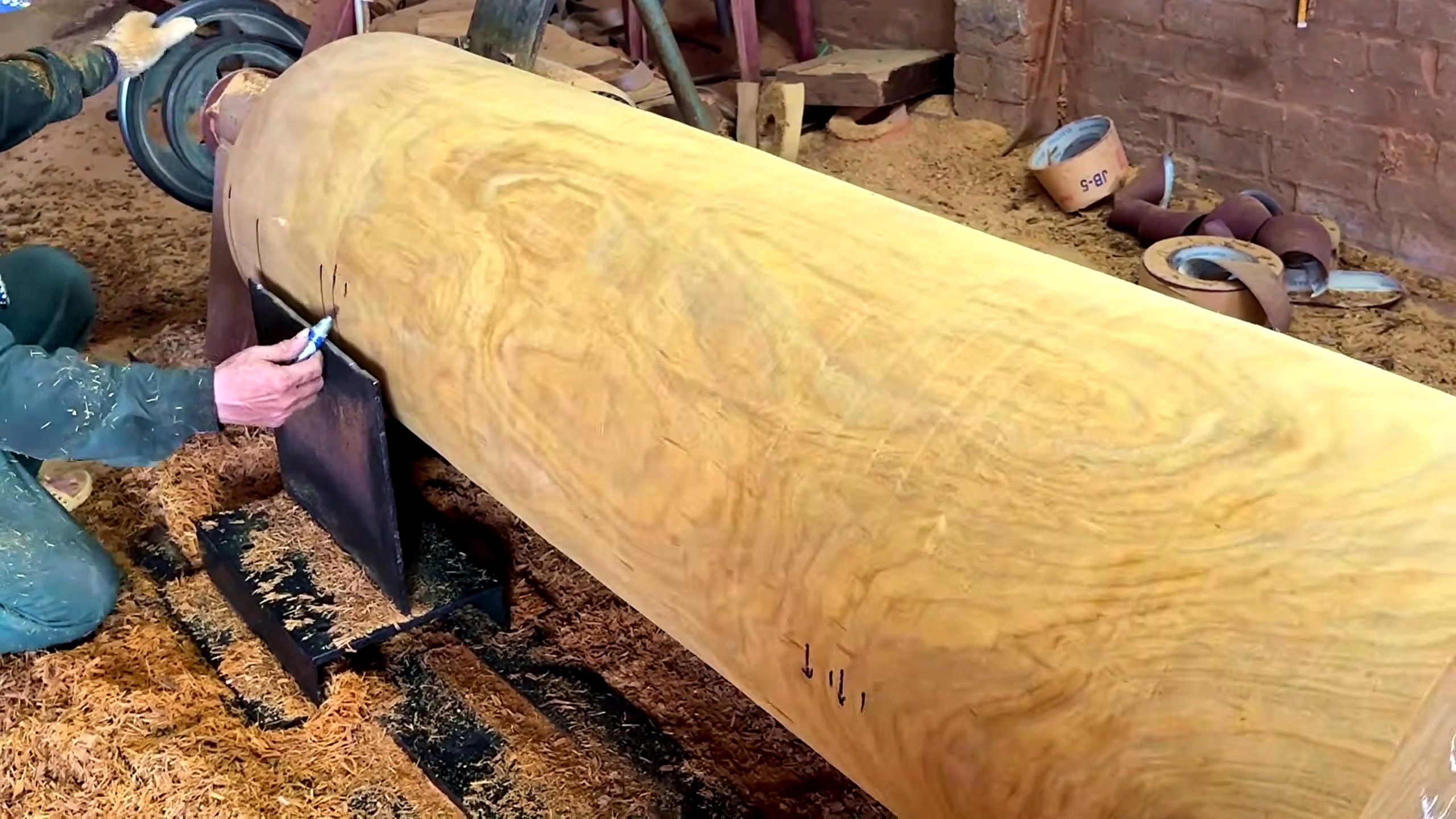 large wood log lathe turning process - the large blank rounded between centers into a readable cylinder