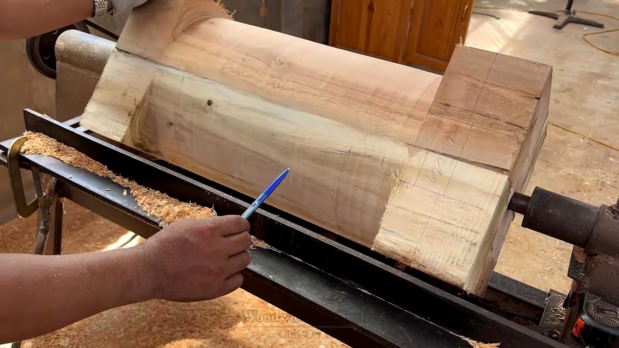old wood furniture carpentry project - a large wood component on the lathe with layout lines and surface checks