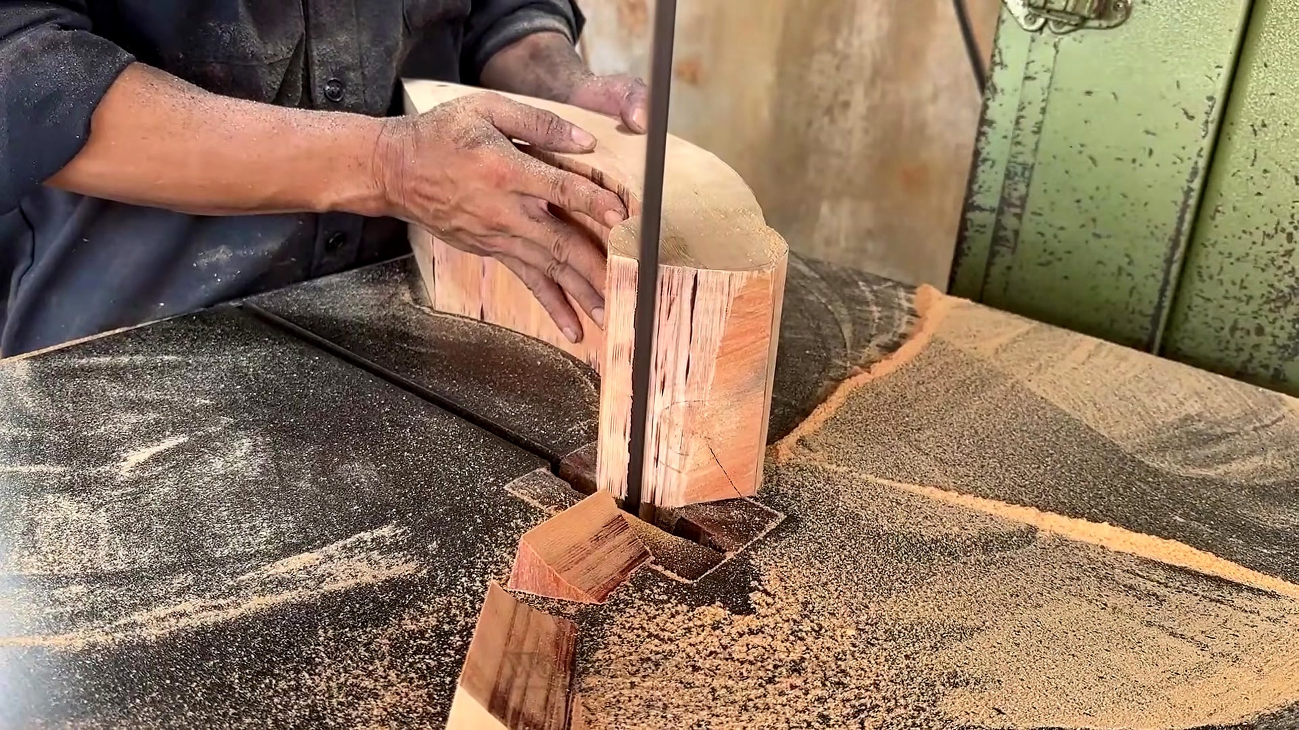 segmented round wood table making process - a bandsaw cutting the first curved or tapered furniture component