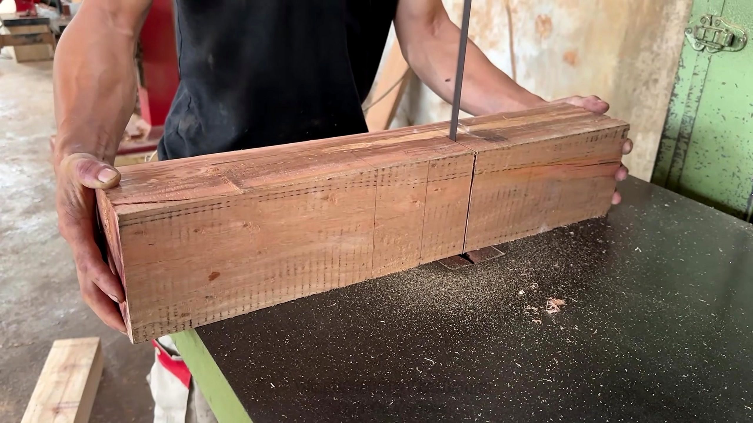 segmented round wood table making process - marked reddish stock staged for repeatable bandsaw cuts