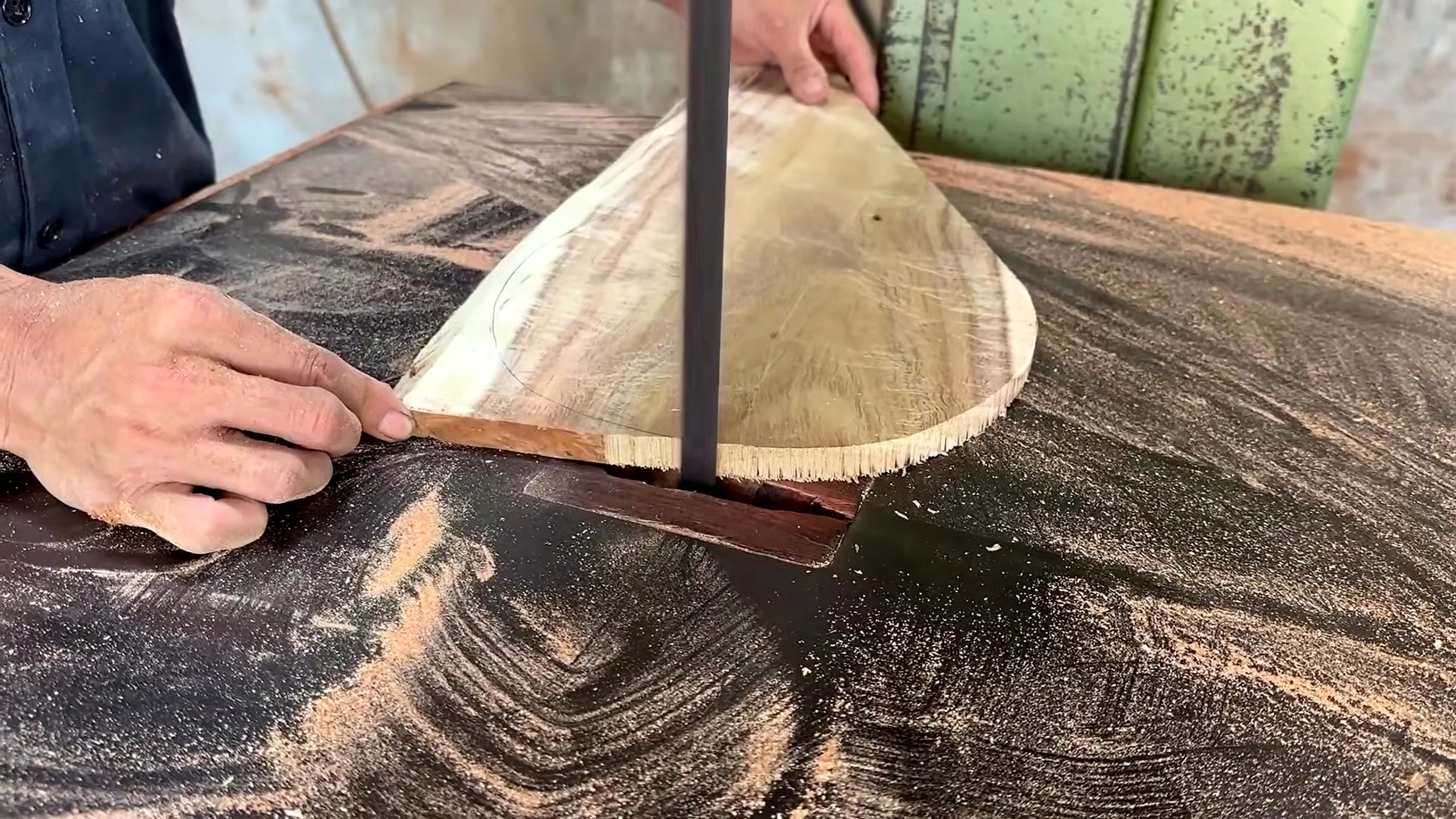 segmented round wood table making process - a fan-shaped tabletop sector being trimmed to its curved boundary