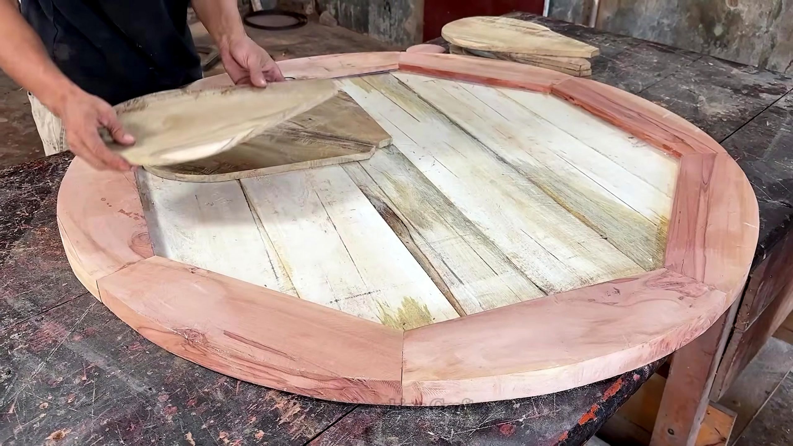 segmented round wood table making process - radial tabletop pieces dry-fitted inside a contrasting outer ring