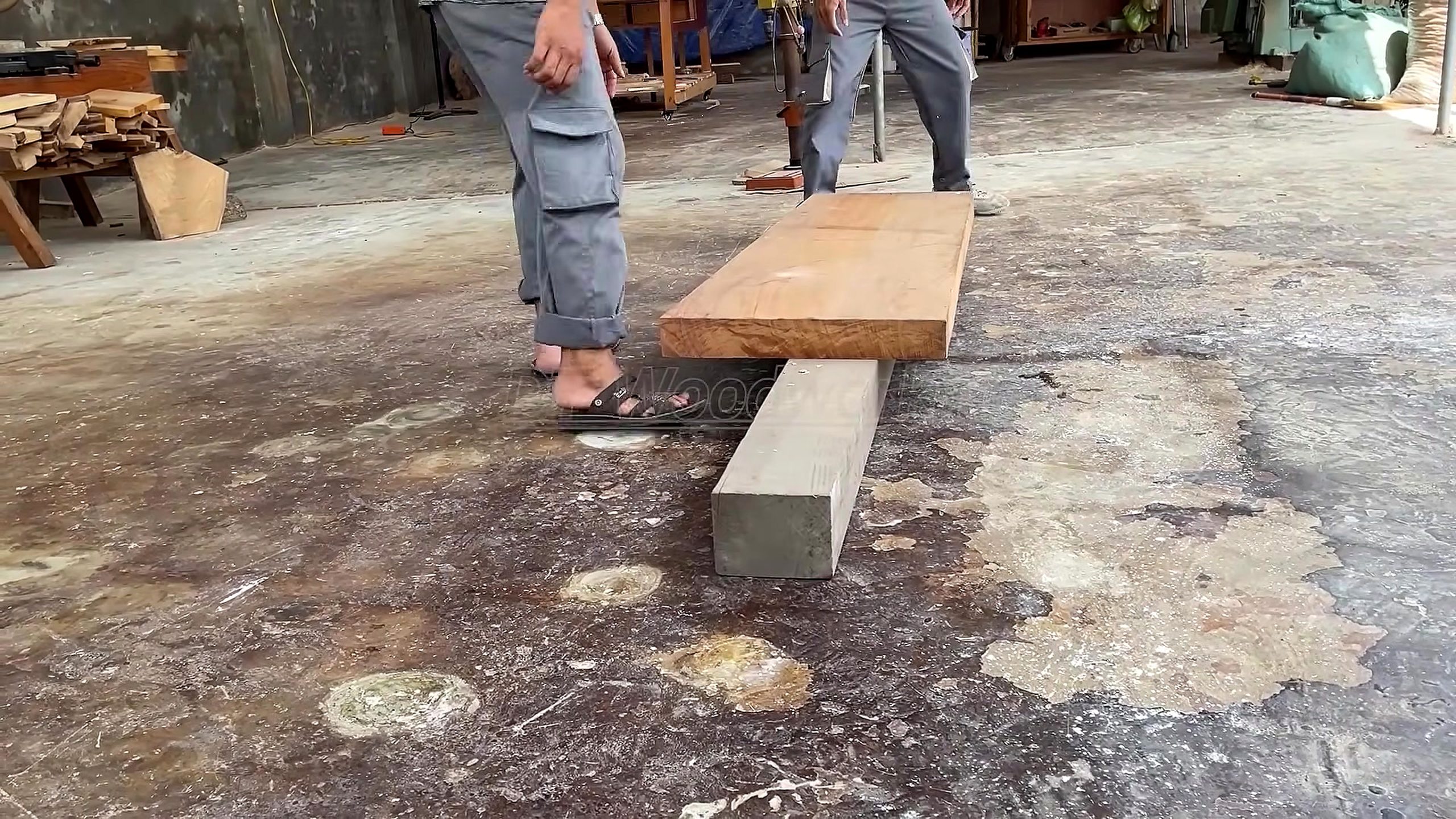 solid wood furniture frame joinery process - a broad thick board being inspected and staged before furniture cutting