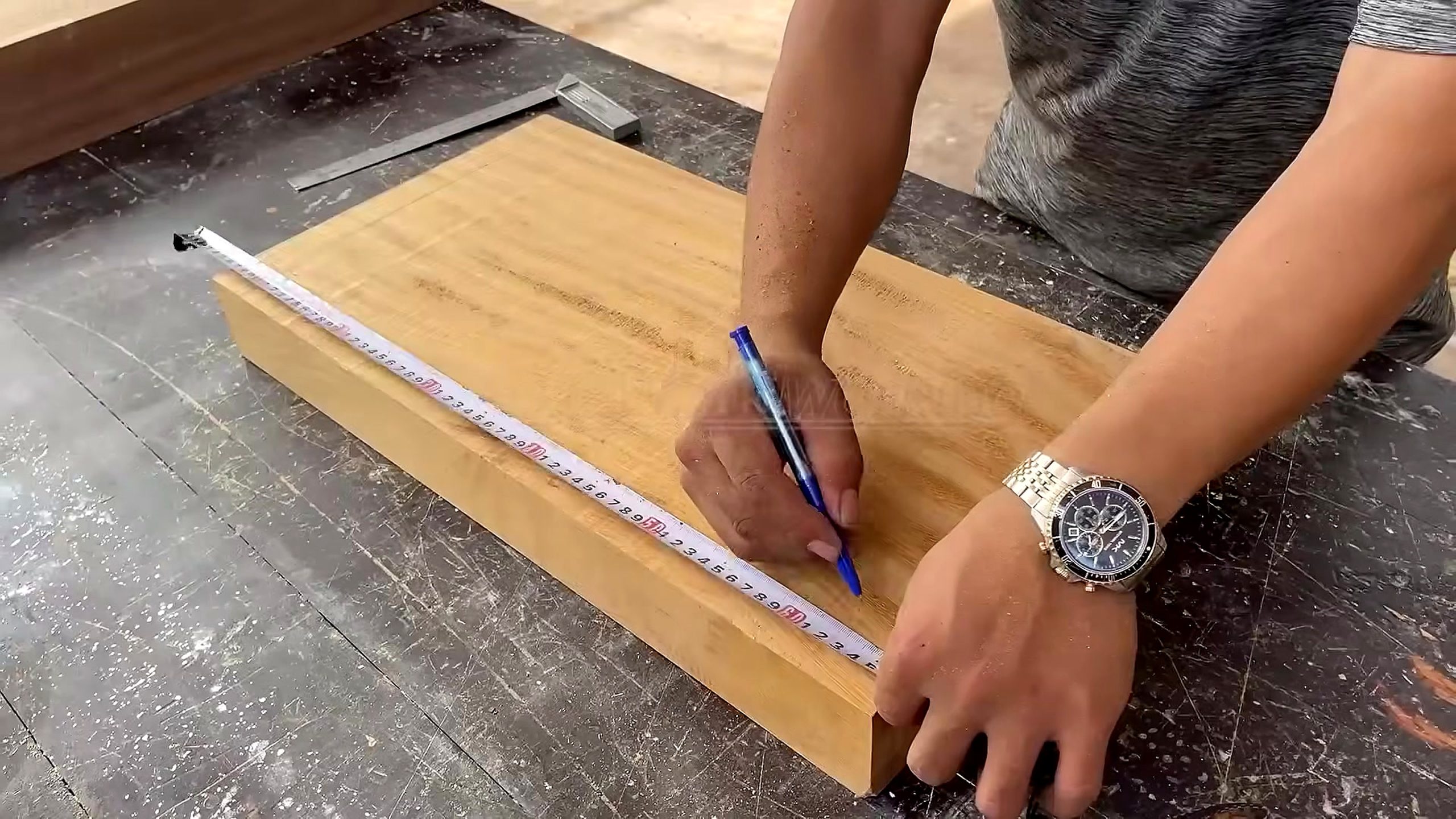 solid wood furniture frame joinery process - a rectangular panel being measured and marked across its face