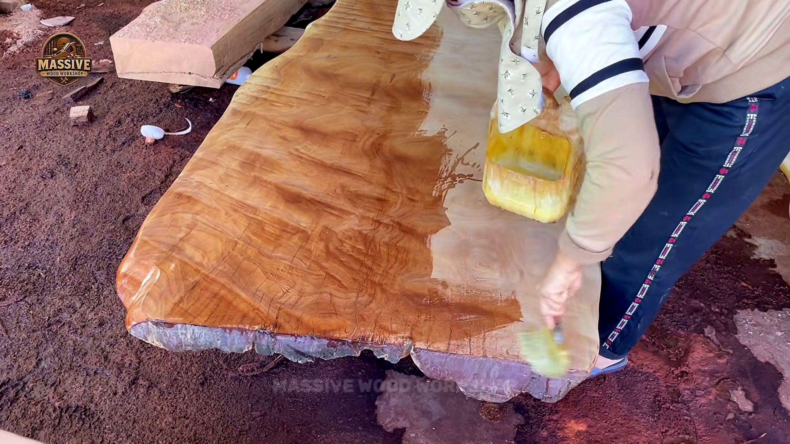 ton ancient timber became most extraordinary worker brushing liquid across a giant live-edge slab