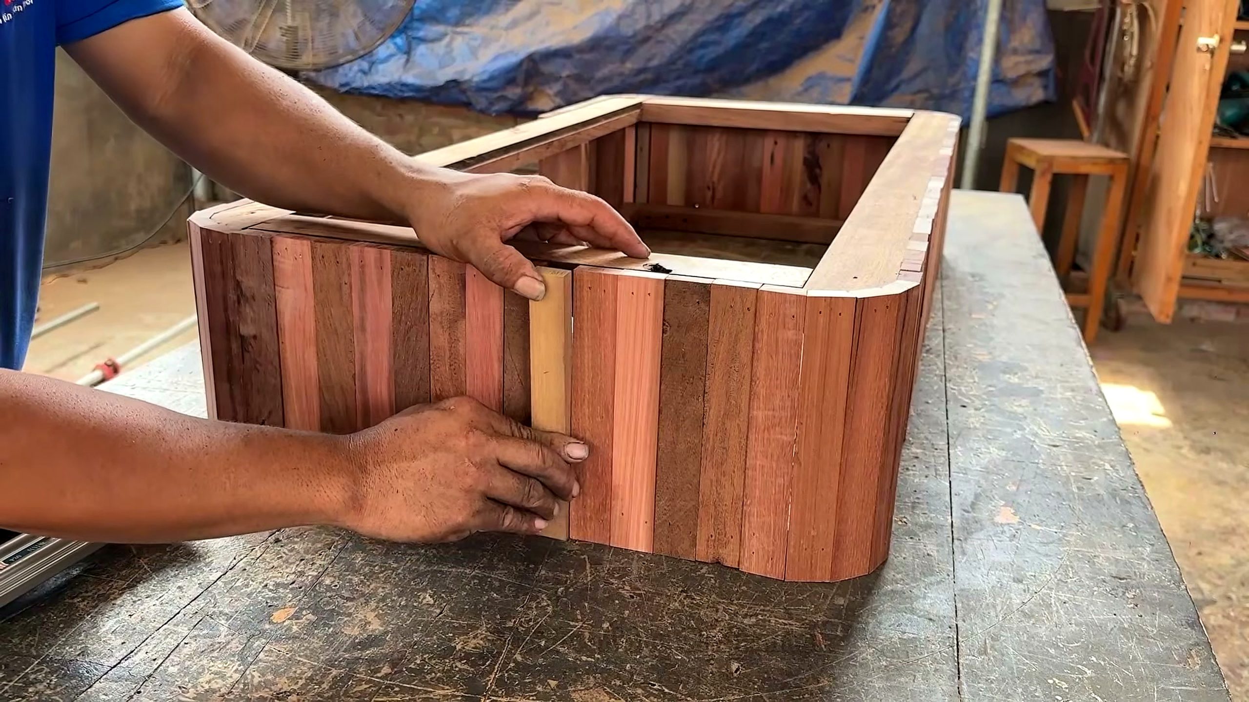 using centuries old decayed warped wood - a rounded slat shell being test-fitted before the final inside fastening