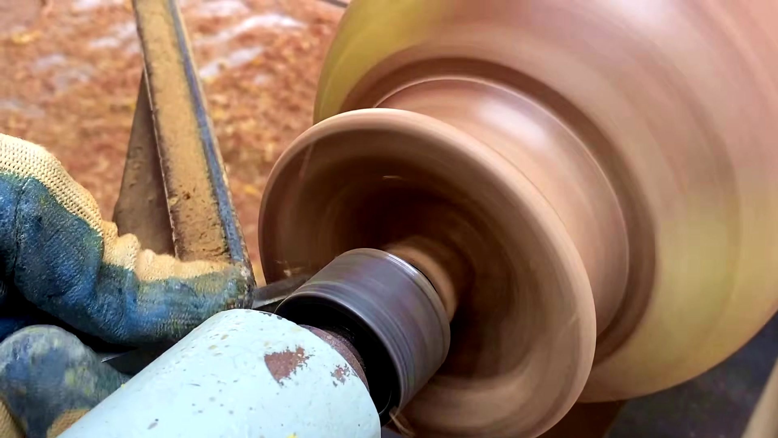 wooden tool lathe turning process - the rounded wooden form after later profile cuts and inspection