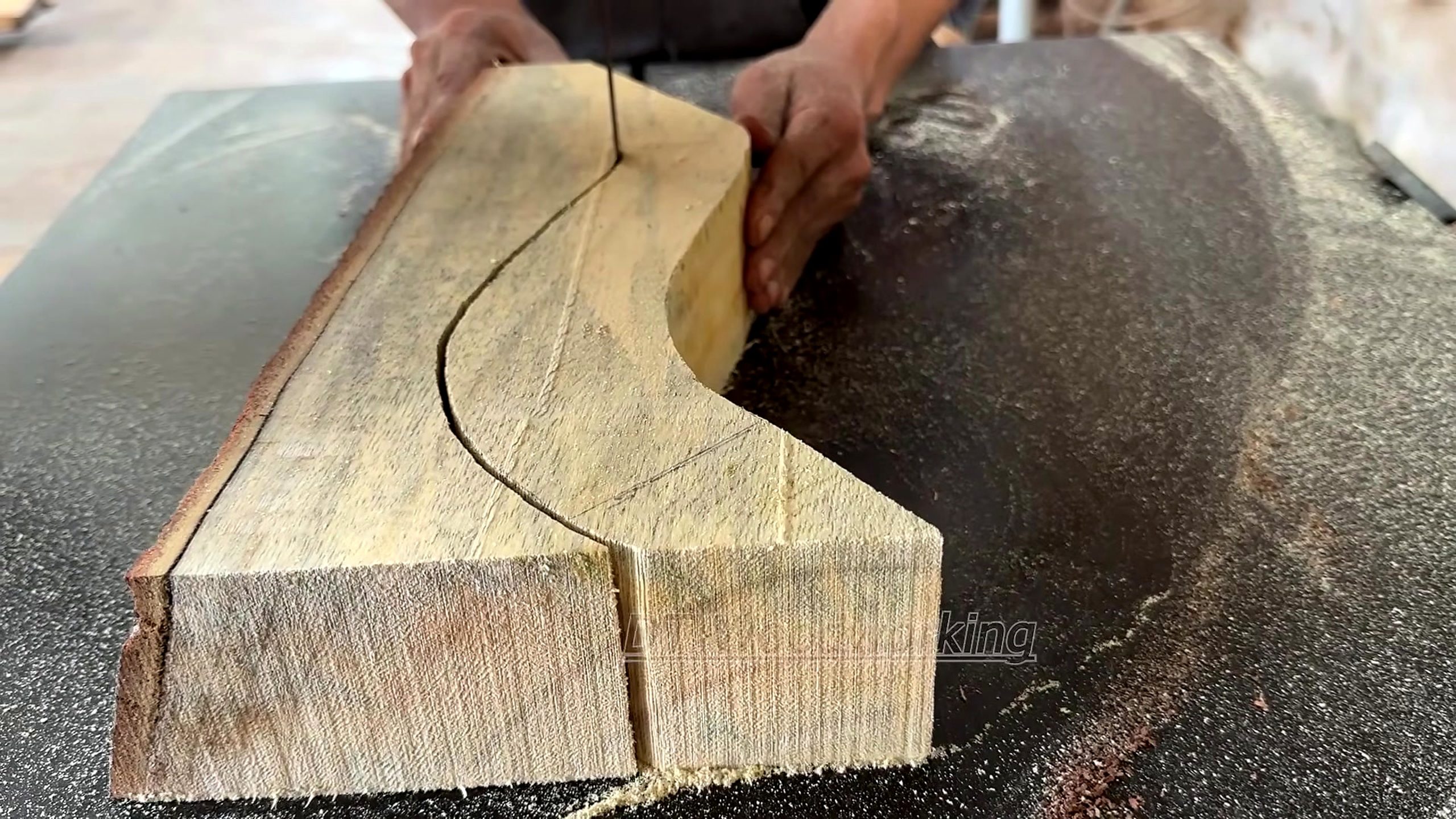 geometric marquetry furniture making process - a thick component following its curved layout line through the bandsaw