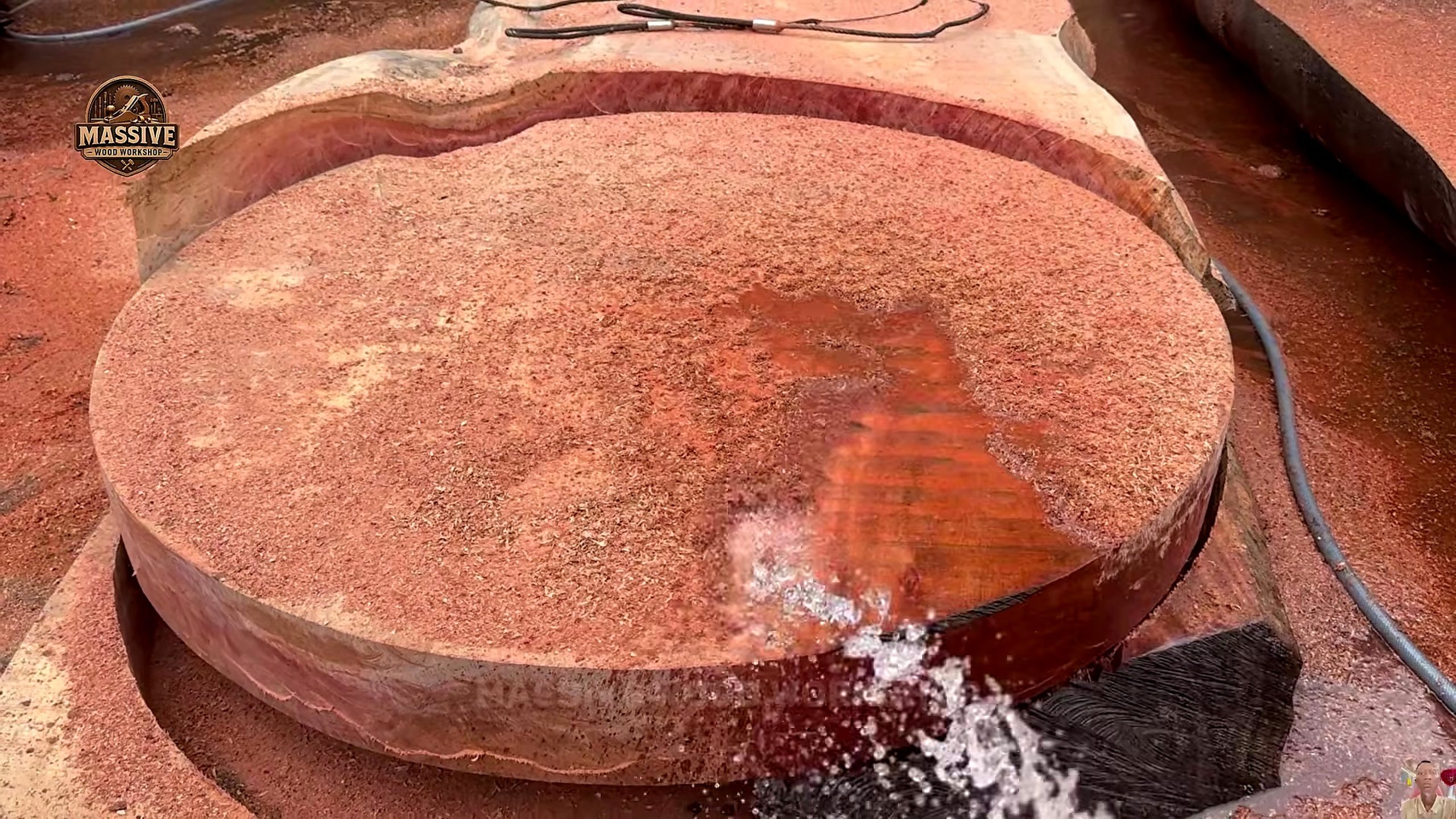 giant log bandsaw slab table process - a circular tabletop blank being rinsed inside the wider slab perimeter