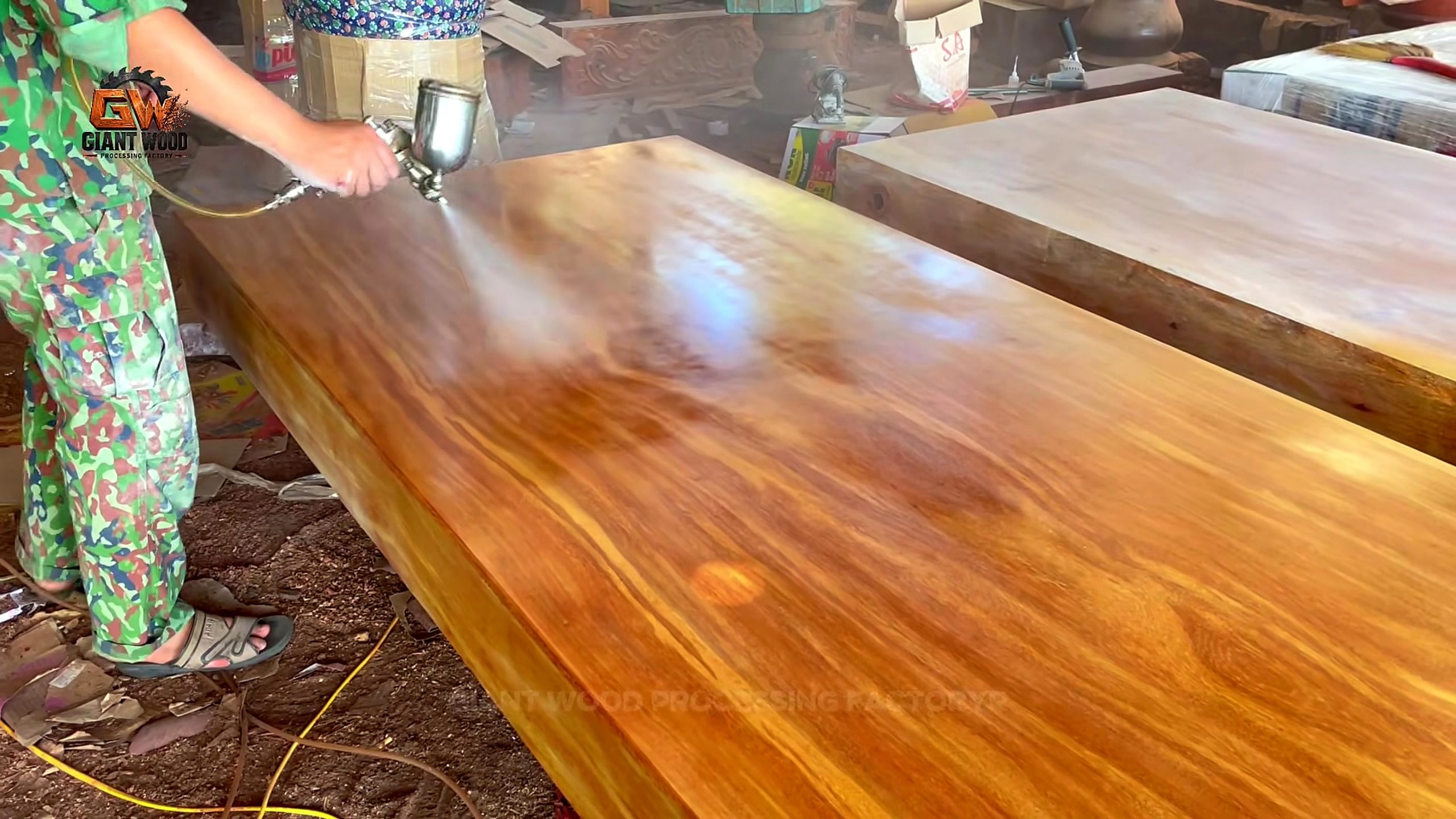 giant log vertical bandsaw sculptural table process - spray finish creating a visible wet-versus-dry transition across the broad tabletop