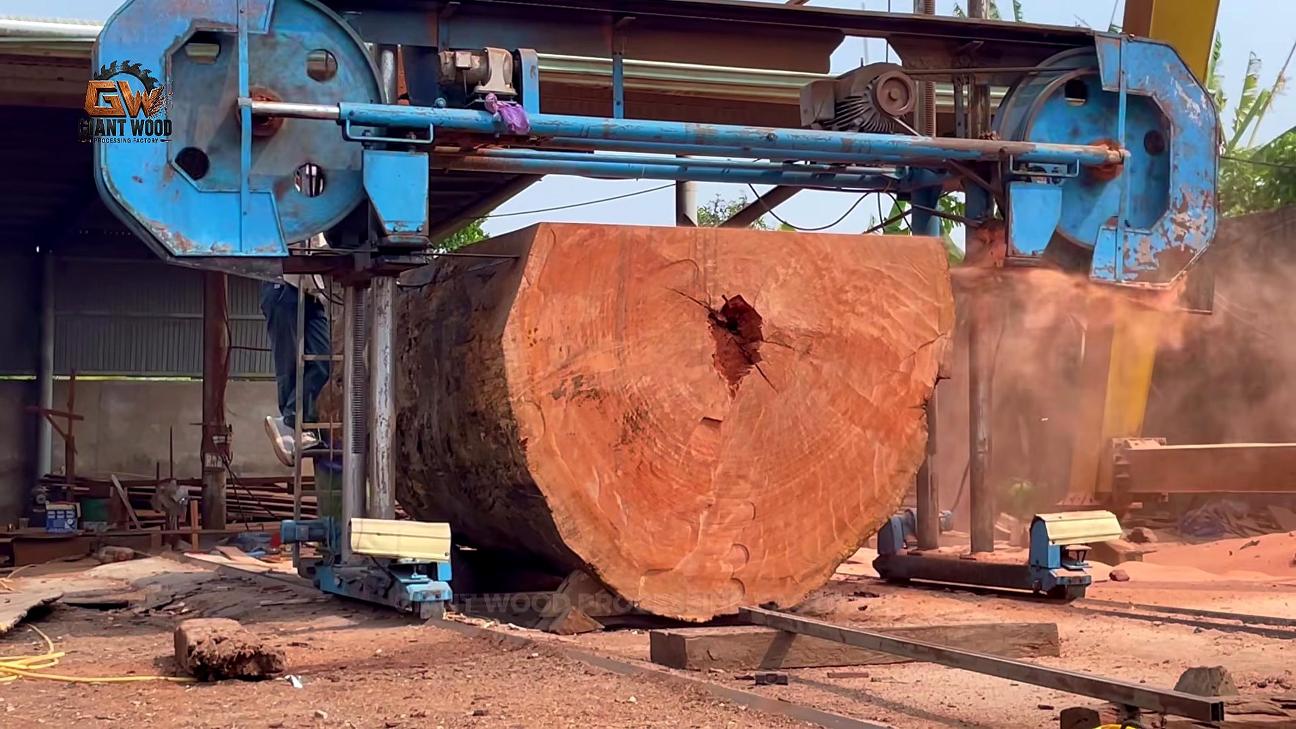 oversize log bandsaw mill process - a later vertical-bandsaw pass progressing across the oversize workpiece