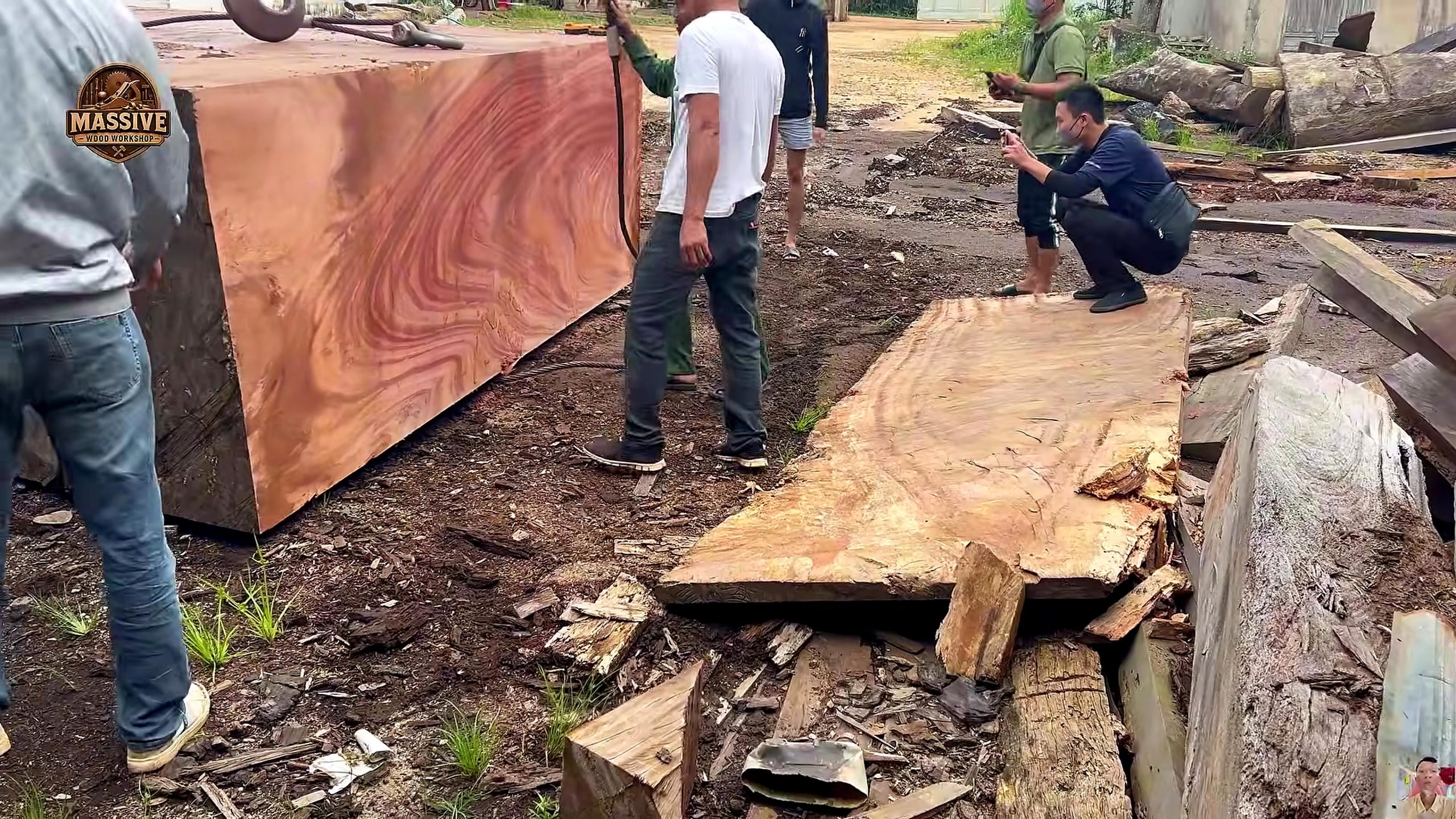 weathered giant timber round table process - the newly opened red-brown grain face being inspected after early breakdown