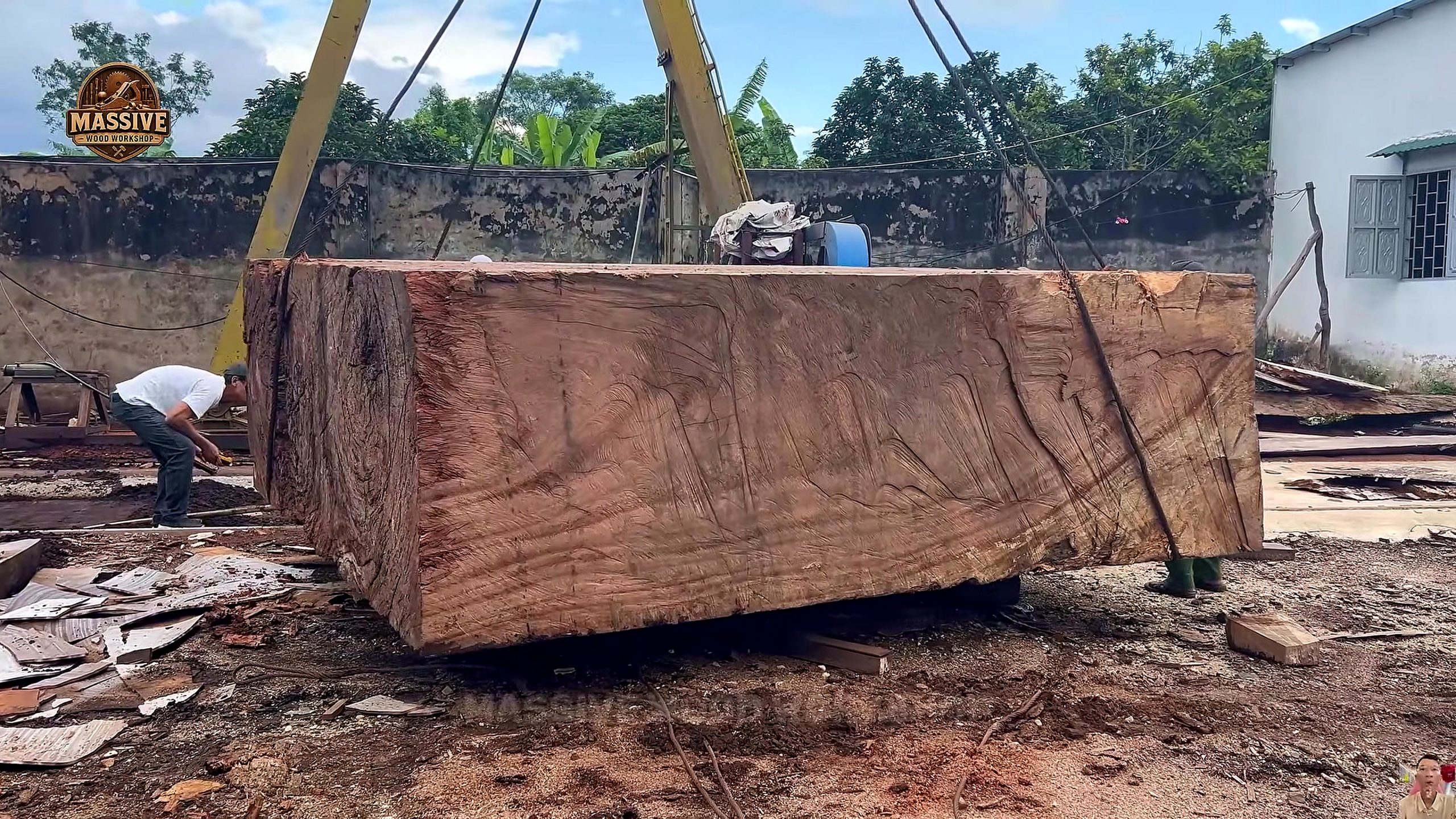 weathered giant timber round table process - the weathered squared timber block suspended for intake and face inspection