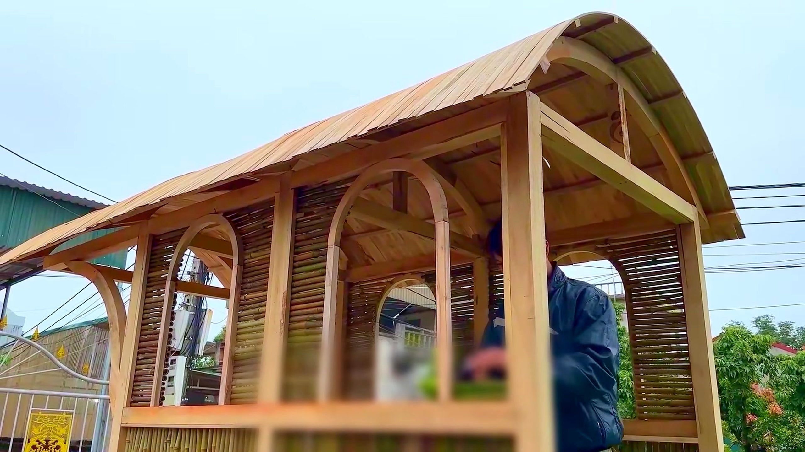 wood and bamboo pavilion build with miter saw - the open wood-and-bamboo pavilion with repeated arches and wall infill in place