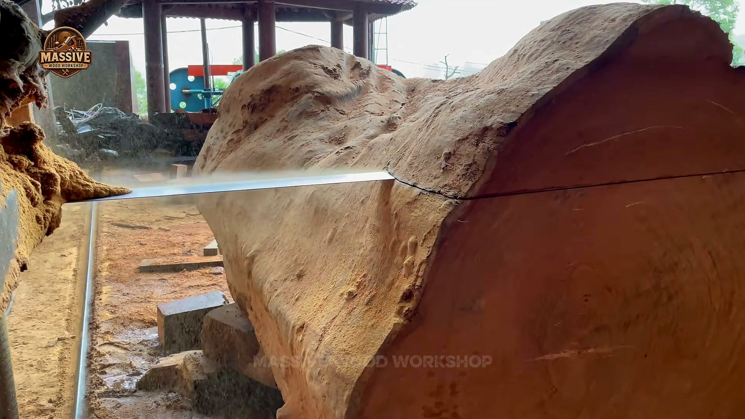dangerous tree long blade cutting across a thick reddish slab